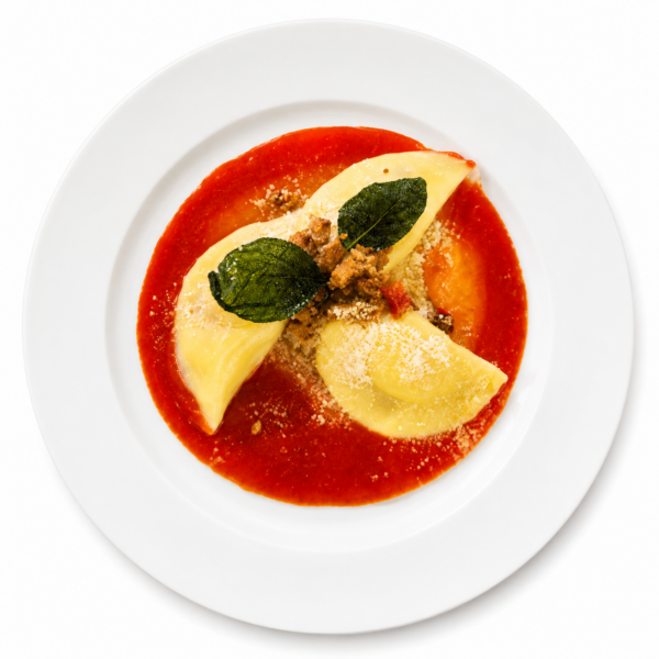 Ravioli filled with burrata on tomato cream, diced grilled vegetables and basil butter
