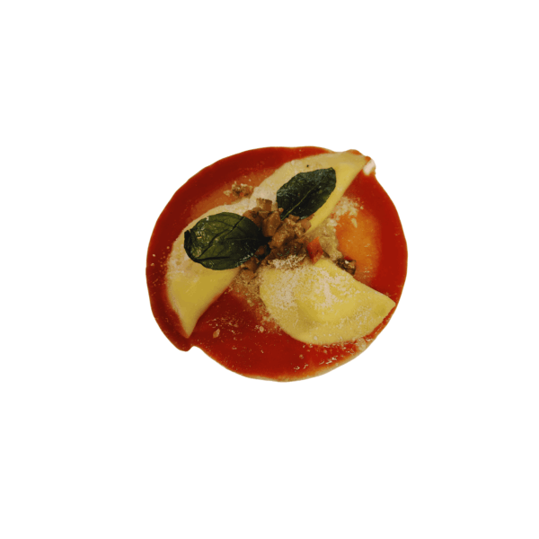 Ravioli filled with burrata on tomato cream, diced grilled vegetables and basil butter