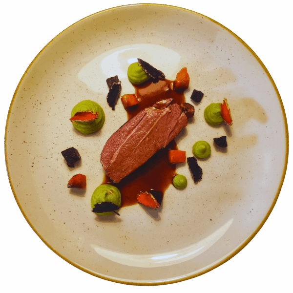 Lamb shank with cashew sauce, pea puree and roots