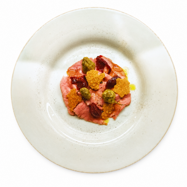 Carpaccio vom rosa gegarten Roastbeef mit Puntarelle, rotem Zwibelkonfito, Parmesanchips und fermentiertem Fenchelsalat