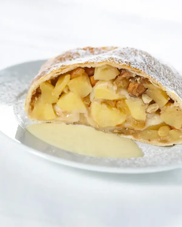 Homemade apple strudel with vanilla sauce