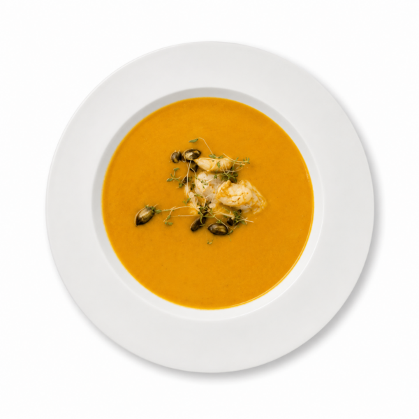 Pumpkin cream soup with ginger, coconut milk, and king prawns