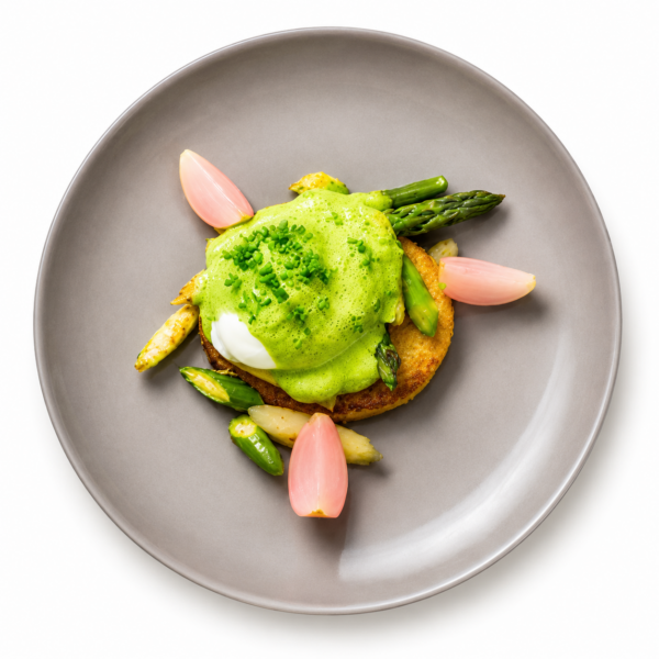 Potato fritters with poached free-range egg on roasted asparagus, wild garlic foam, and cress